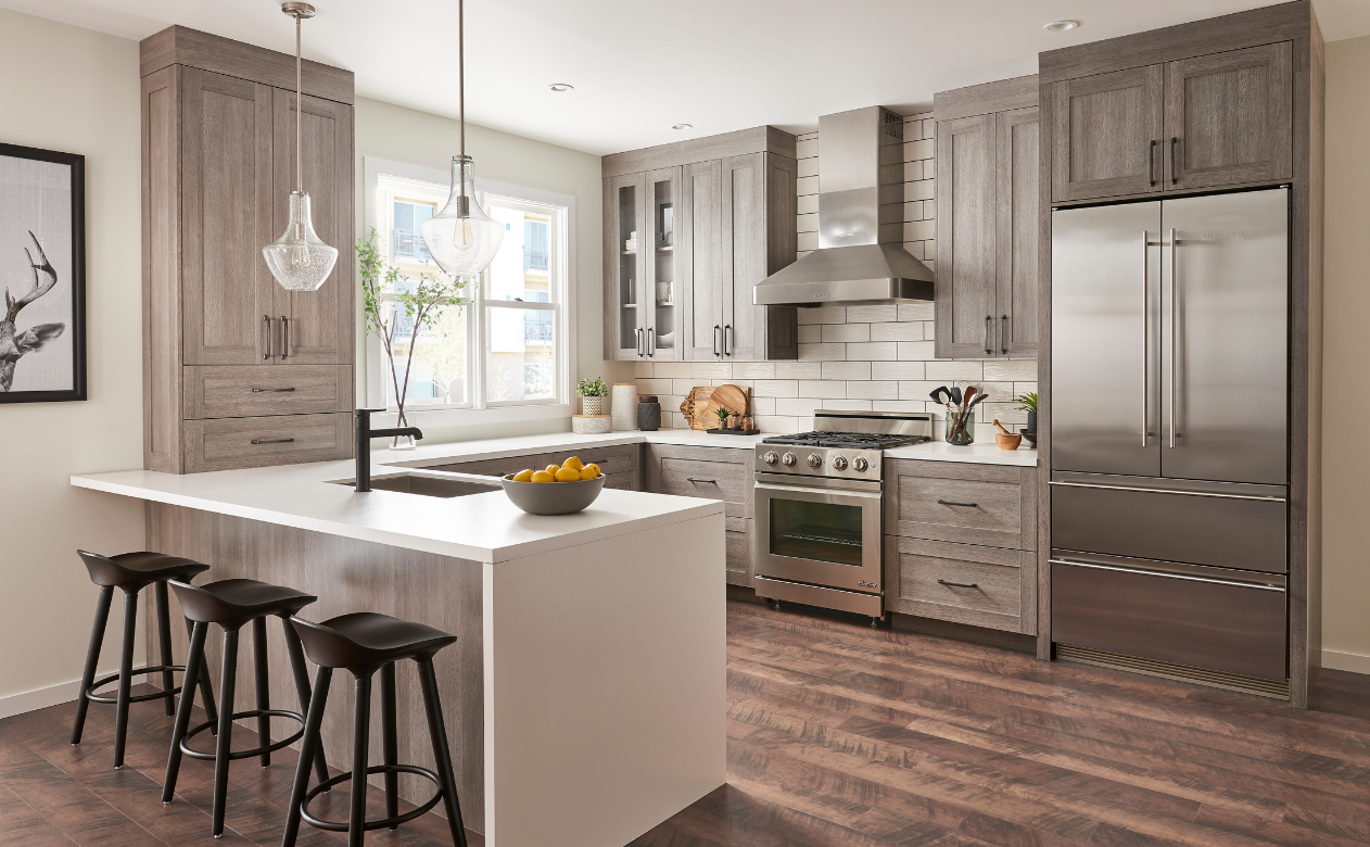 Kitchen with gray cabinetry and waterfall countertop
