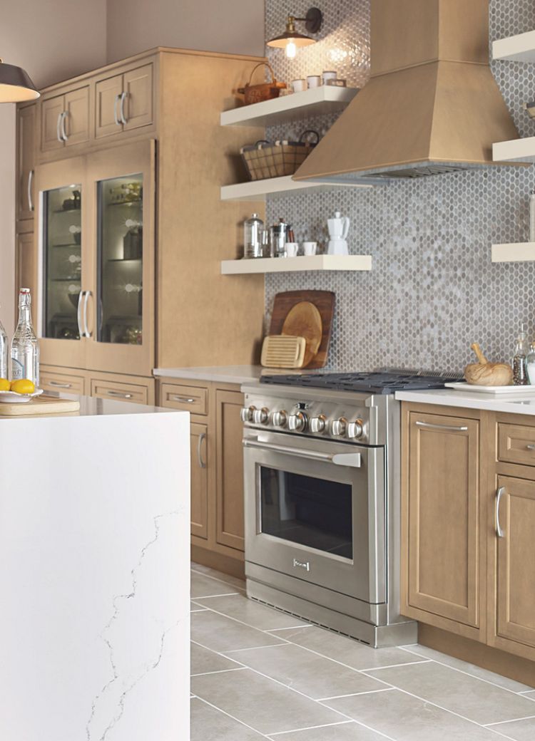 patterned tile kitchen backsplash in a kitchen with black and white cabinets