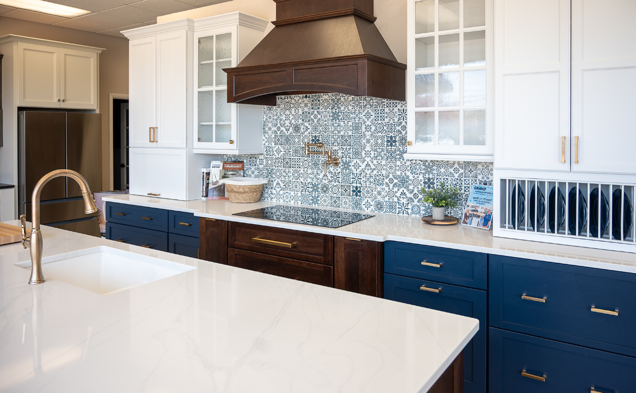 custom white countertops in a kitchen with blue, white and dark cabinetry