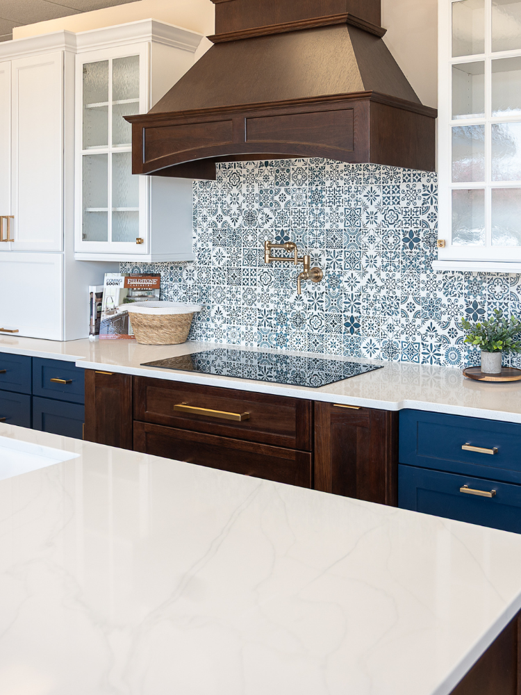 custom white countertops in a kitchen with blue, white and dark cabinetry