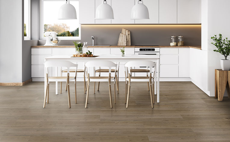 vinyl plank flooring in kitchen with white cabinets and dining table