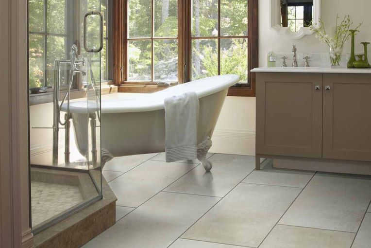 large rectangle bathroom floor tiles in a spacious bathroom with large windows